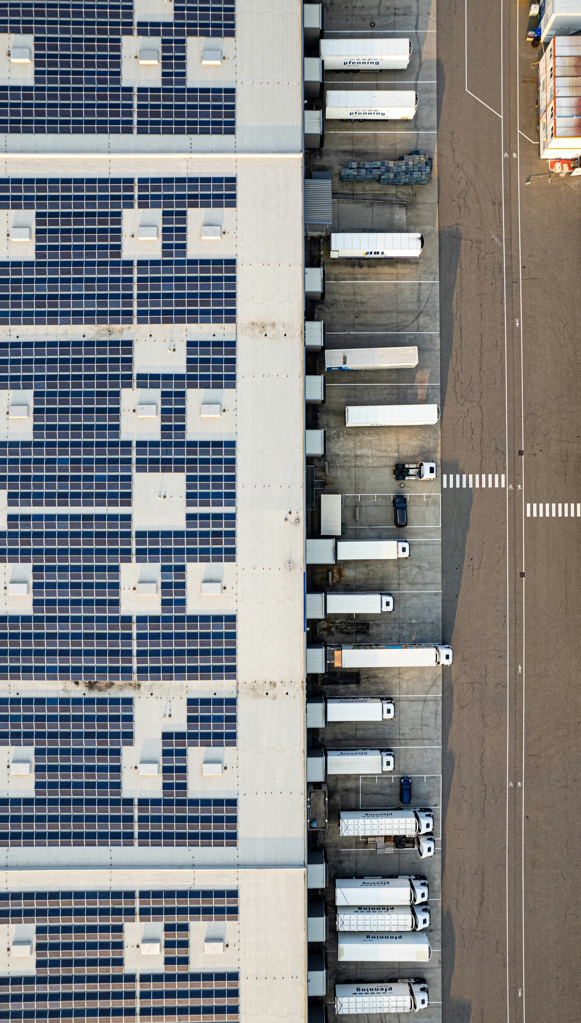 Aerial view of a commercial warehouse with solar panels and loading bays